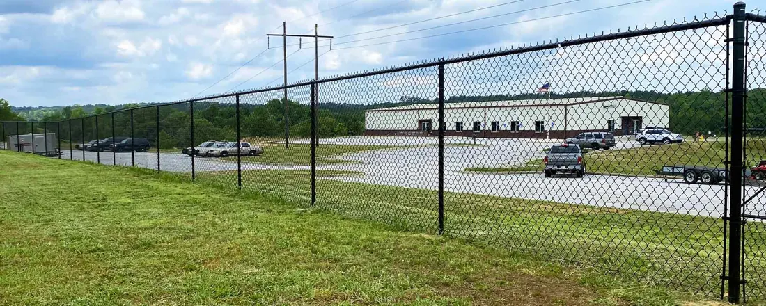 Black chain-link security fence along a commercial property