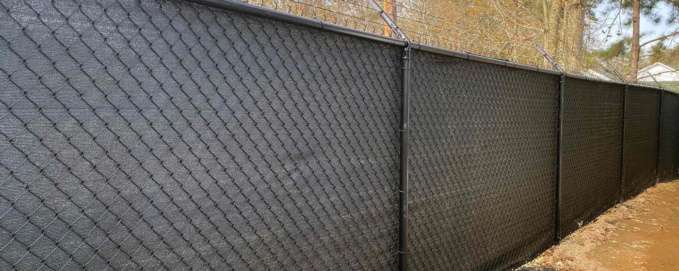 Chain-link fence with light privacy inserts
