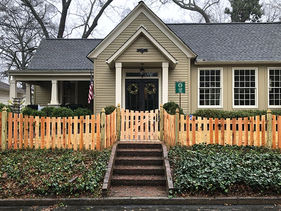 Wood picket fence in front of a home