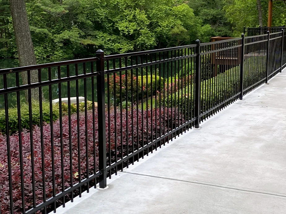 Ornamental metal fence alongside a walkway
