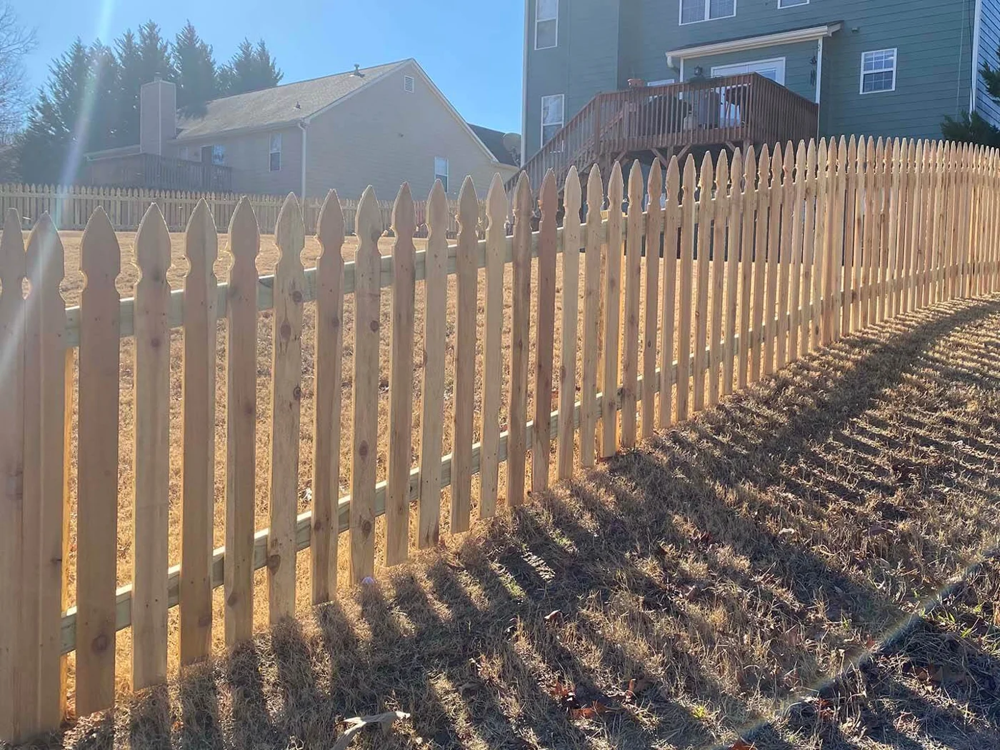 Wood picket fence and gate in evening light