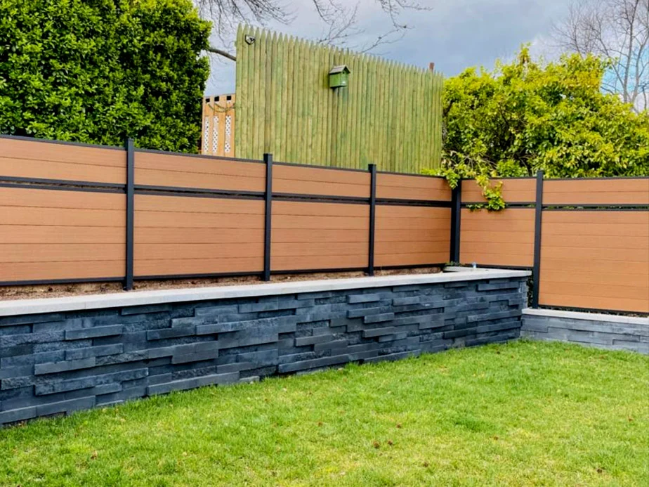 Privacy fence above a retaining feature