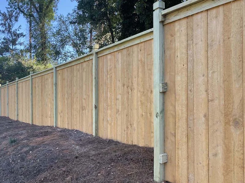 Wood privacy fence with capped posts