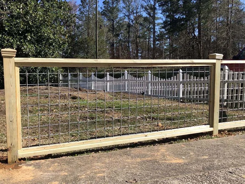 Wood rail fence with wire enclosure