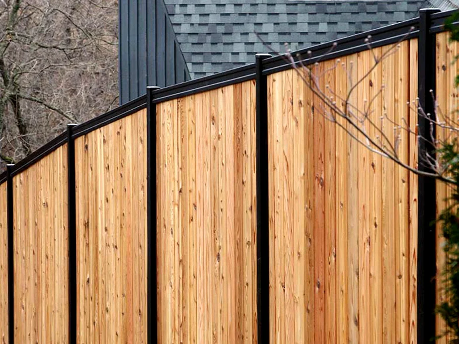 Wood and metal fence following a slope