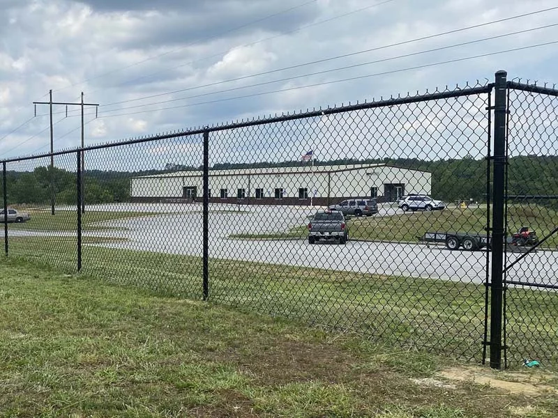 Chain-link perimeter beside a commercial building