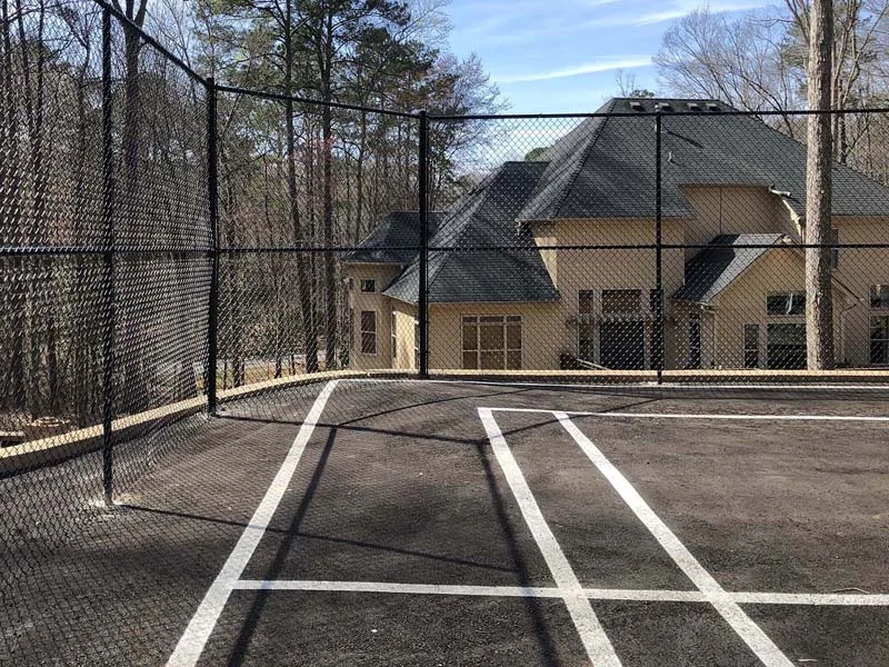 Tall black chain link at a recreation court
