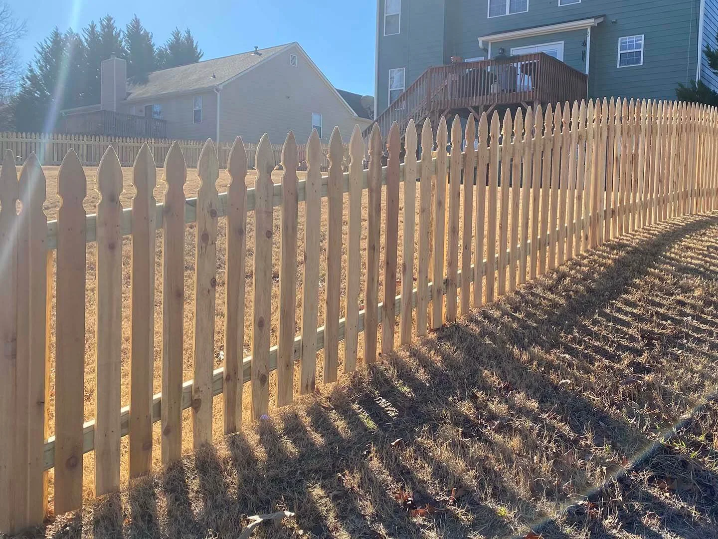Wood picket fence and walk gate in evening light