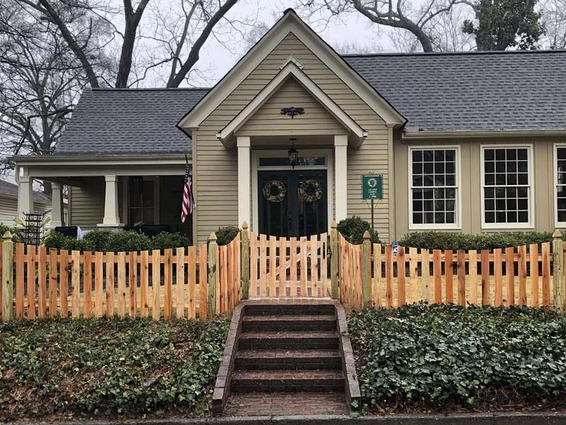 Scalloped wood pickets in a front garden