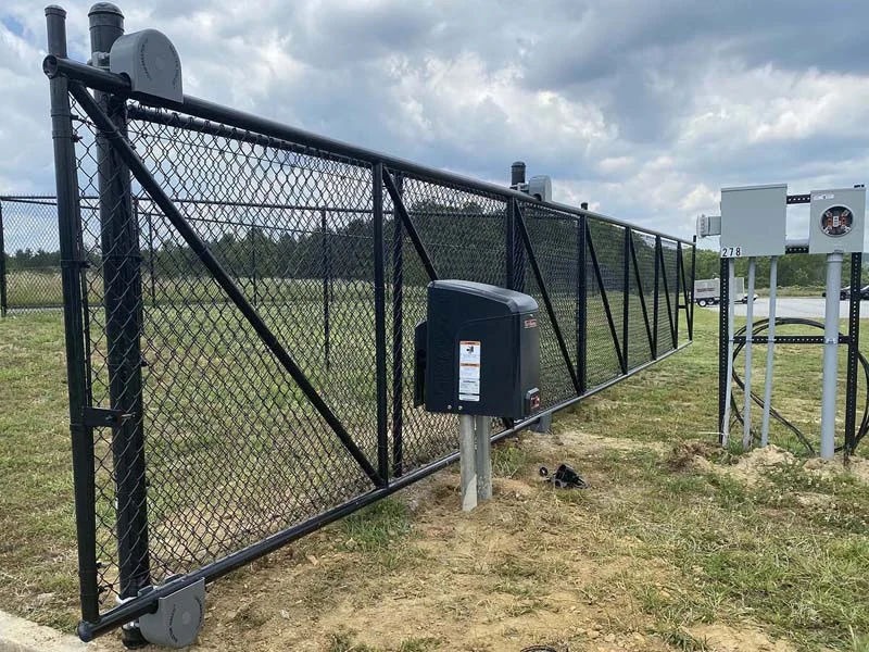 Powered chain-link vehicle gate