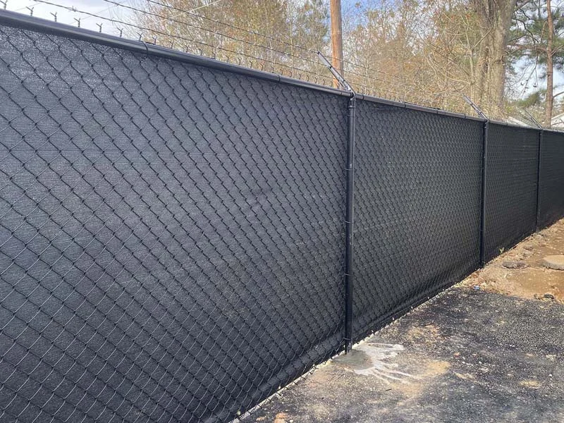 Chain-link fence with closely spaced privacy inserts
