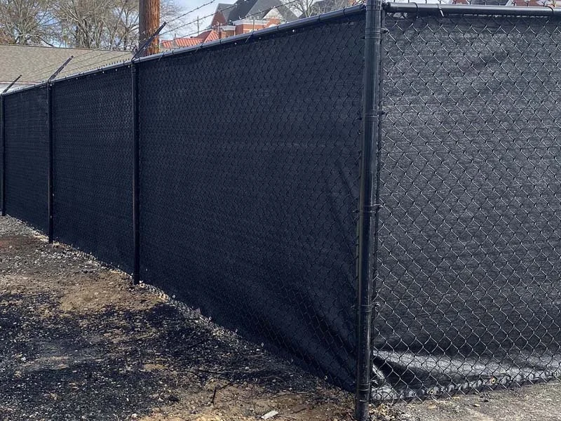 Black chain-link fence with privacy screening