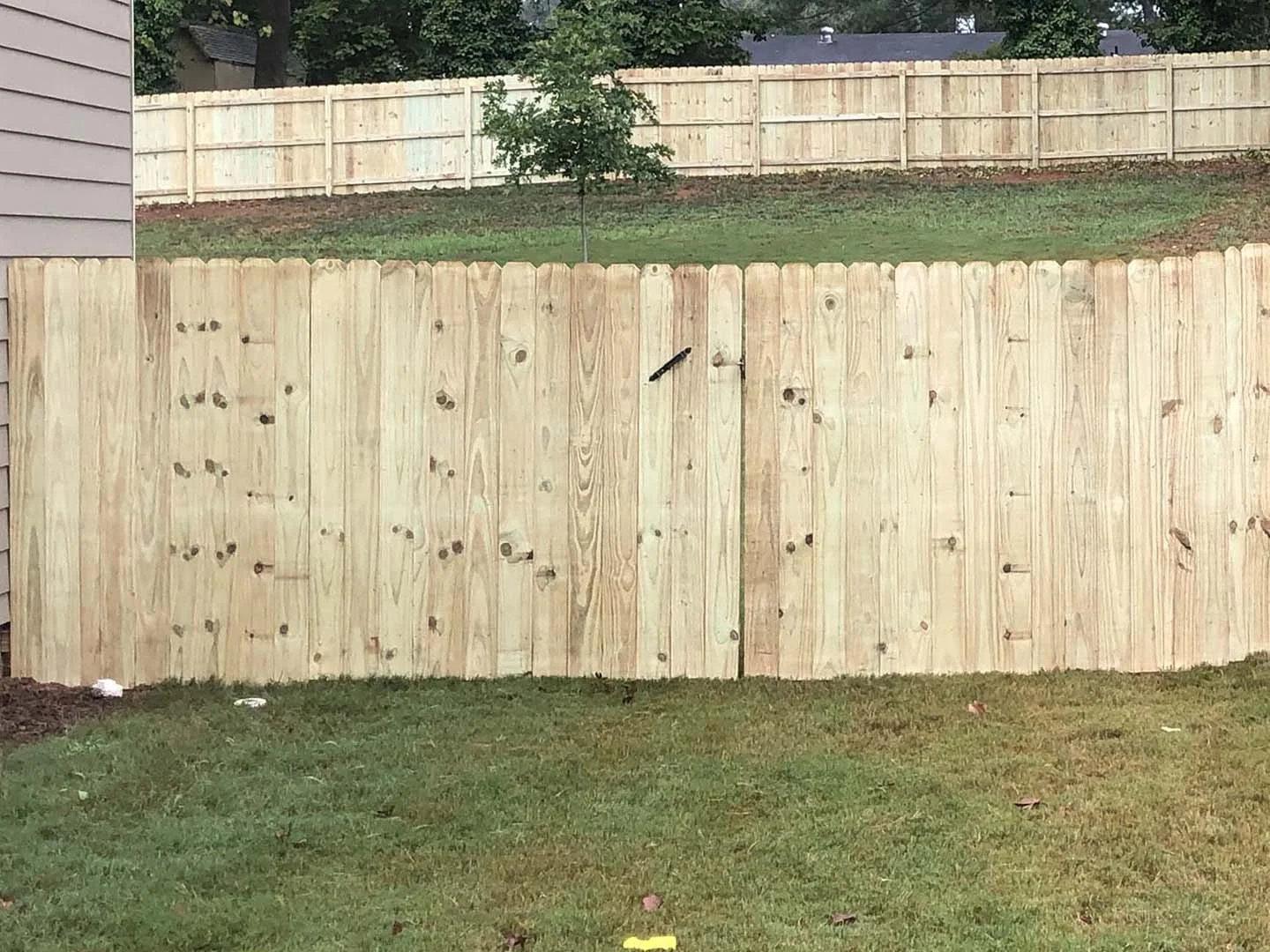 Dog ear wood fence seen from the rail side