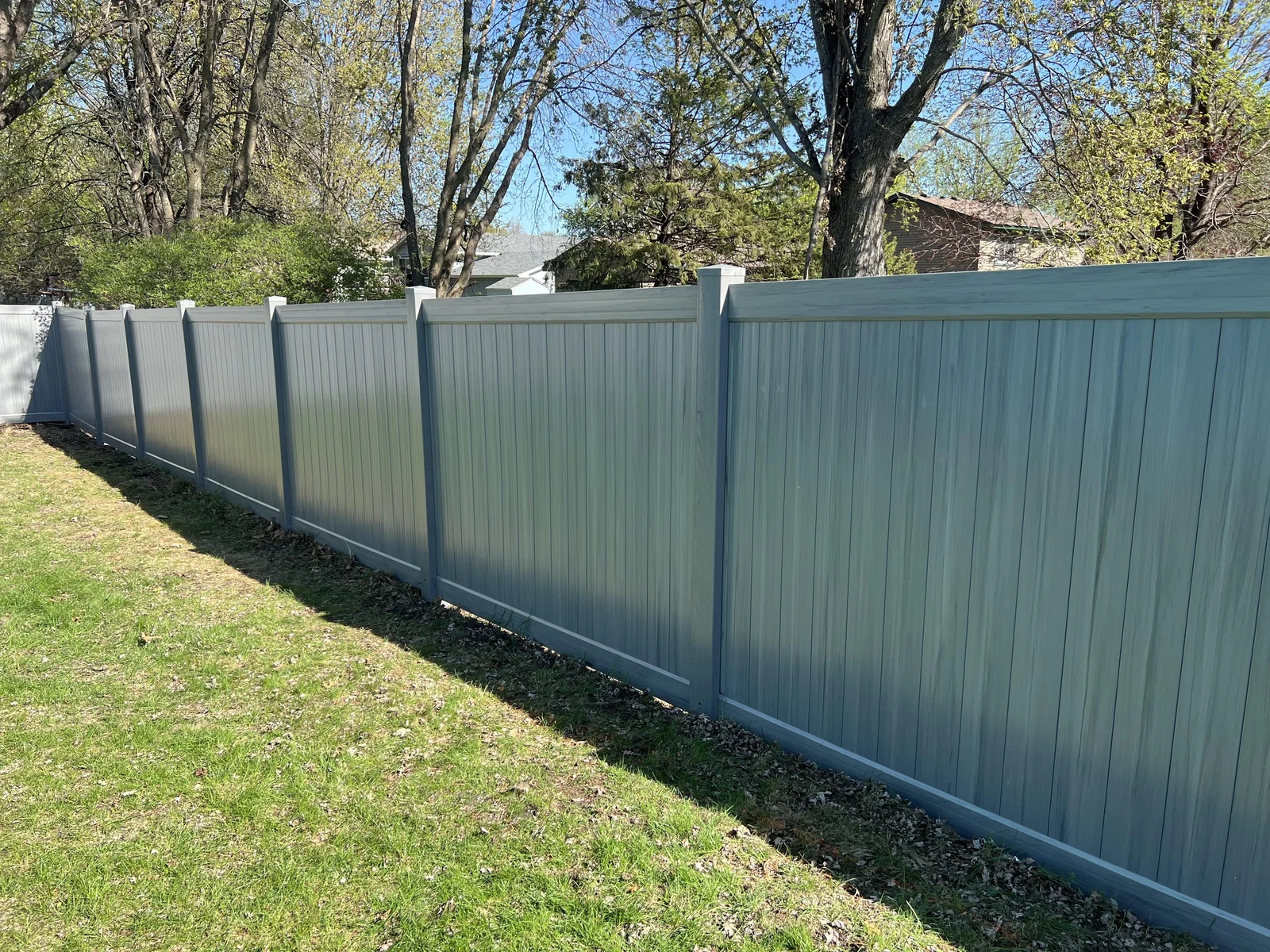 Gray vinyl privacy fence with matching posts