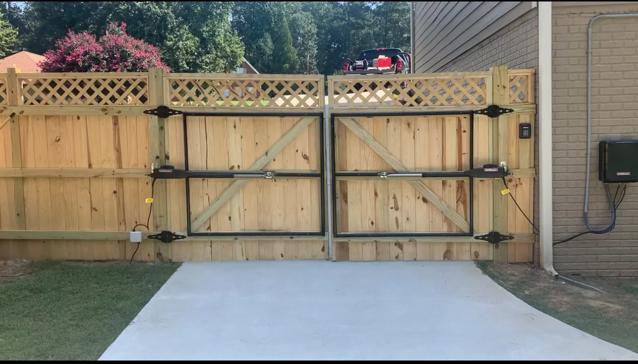 Paired wood gates with lattice detail and gate operators