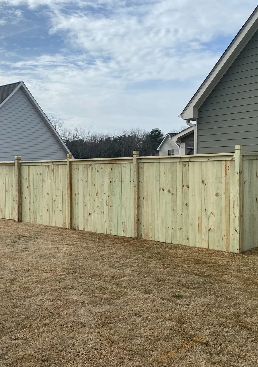 Wood privacy fence with a cap and trim finish