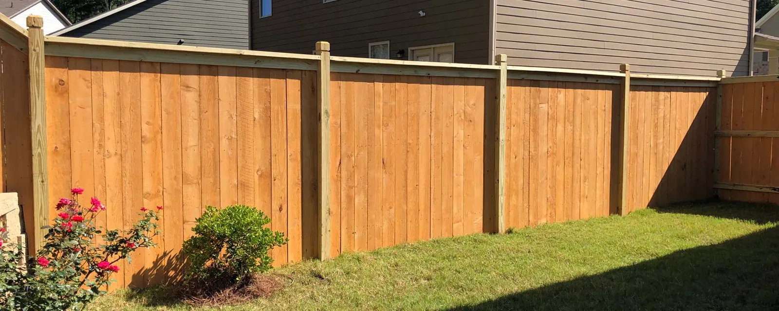 Wood privacy fence with a finished top cap